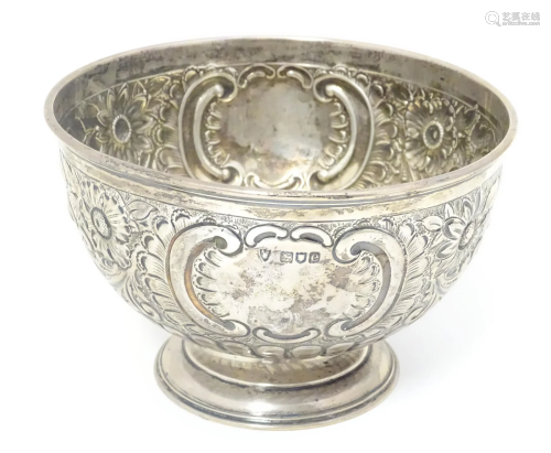 A Victorian silver pedestal rose bowl with embossed floral a...