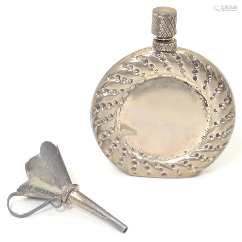 A small silver perfume funnel together with a white metal pe...