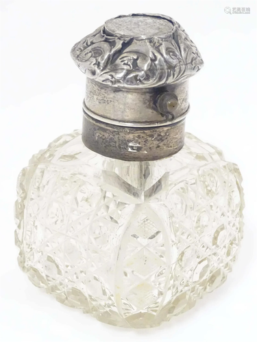 A cut glass scent bottle with silver mount. 4 1.2" high...