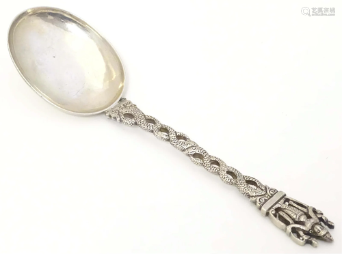 A white metal spoon with snake decoration to handle surmount...