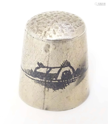 A white metal thimble with niello decoration depicting a riv...