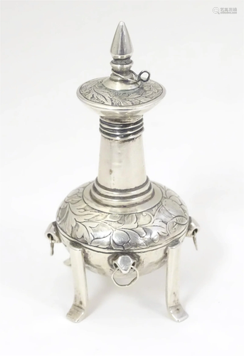 A white metal scent bottle with engraved decoration formed a...