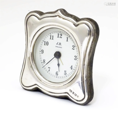 A late 20thC alarm clock with silver surround hallmarked Bir...