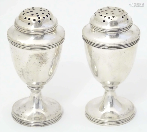 A pair of Victorian silver peppers hallmarked Sheffield 1898...