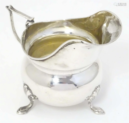 A silver cream jug hallmarked Chester 1906 maker J & R G...