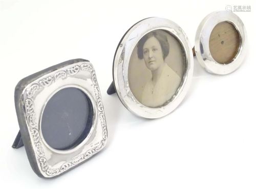 Three assorted photograph frames with silver and white metal...