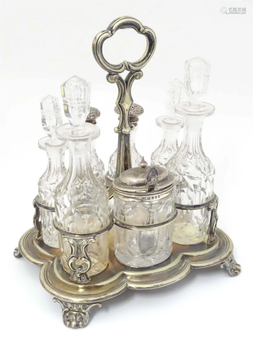 A 19thC silver plate cruet stand with a set of 7 cut glass c...