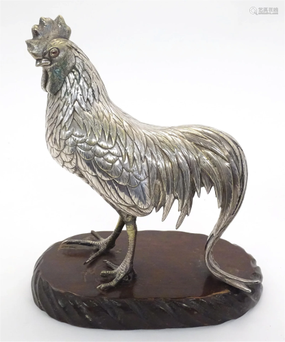 A 20thC Continental silver plate model of a cockerel upon an...