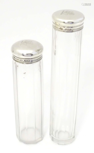 Two glass toilet bottles with facet detail and silver tops h...