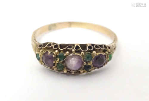A late 19th / early 20thC yellow metal ring set with purple ...