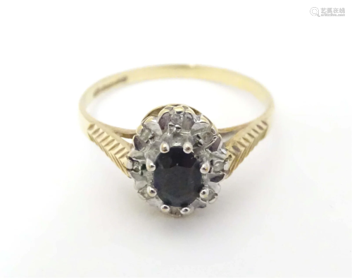 A 9ct gold ring set with central blue spinel bordered by dia...