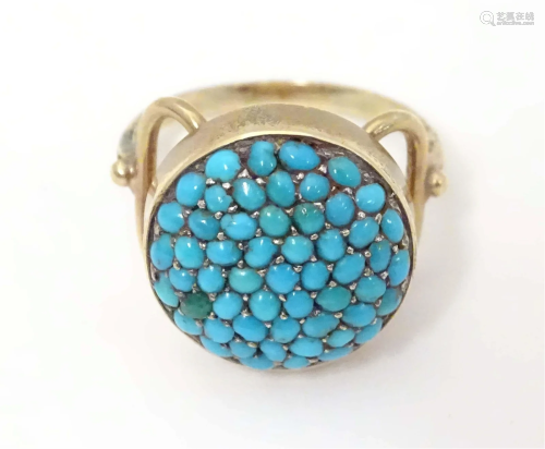 An early 20thC yellow metal ring set with turquoise cabochon...
