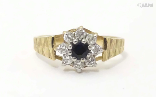A 9ct gold ring set with central blue spinel bordered by whi...