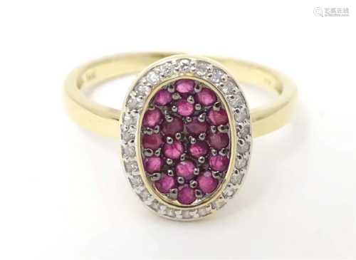 A 14ct gold ring set with ruby coloured spinels bordered by ...