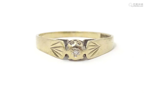A 9ct gold ring set with central diamond. Ring size approx. ...