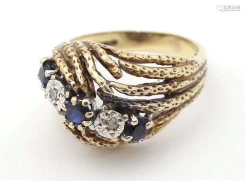 A 9ct gold dress ring set with sapphires and diamonds. Ring ...