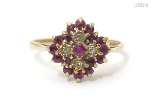 A 9ct gold ring set with rubies and diamonds in a cluster se...