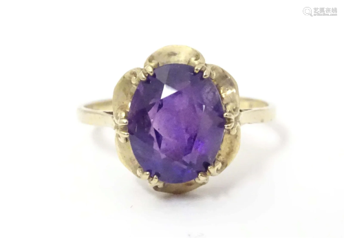 A 9ct gold ring set with central amethyst. Amethyst approx. ...
