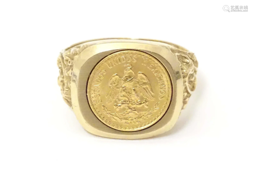 A 9ct gold signet ring set with Mexican coin to centre. Ring...