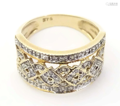A 9ct gold ring set with a profusion of diamonds. Ring size ...