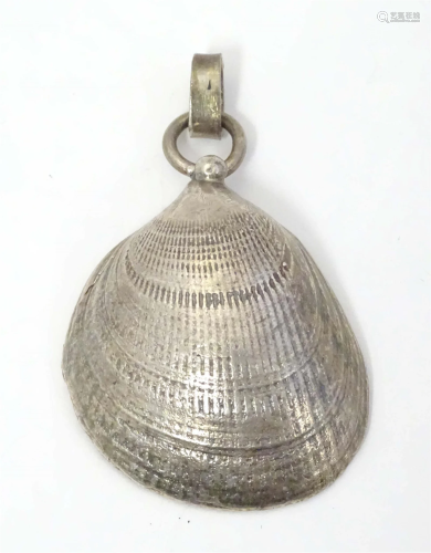 A silver pendant of shell form, hallmarked London 1988. Appr...
