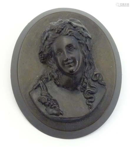 A Victorian jet cameo brooch of oval form depicting a woman ...