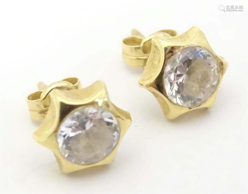 A pair of 18ct gold stud earrings set with white stones in s...