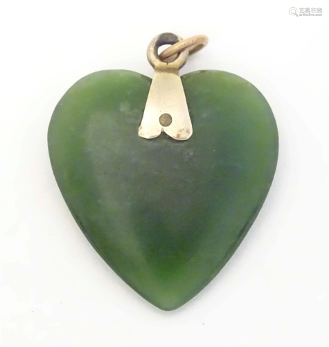 An early 20thC green hardstone pendant of heart form in the ...