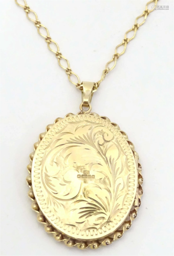A 9ct gold pendant locket with engraved acanthus leaf detail...