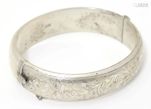 A silver bangle formed bracelet hallmarked Birmingham 1959 m...