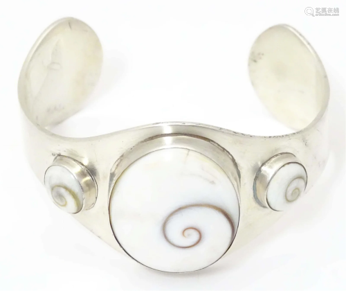 A .925 silver bracelet of cuff bangle form with shiva shell ...