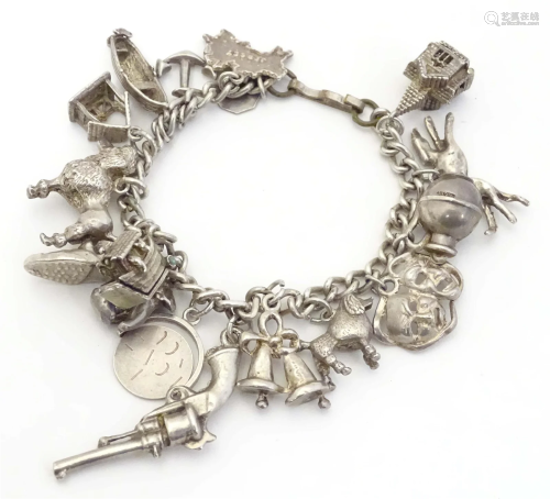 A small white metal and silver plate charm bracelet set with...