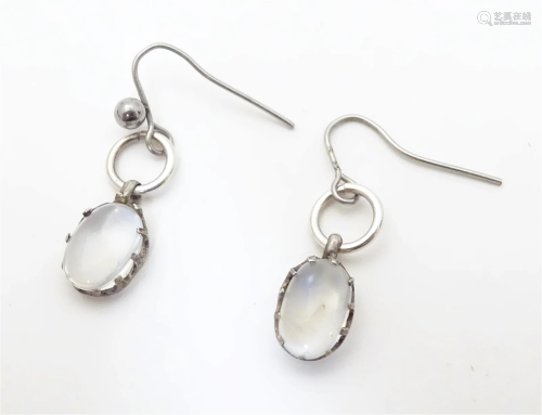 A pair of white metal drop earrings set with moonstone caboc...