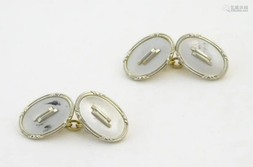A pair of Art Deco cufflinks with mother of pearl style deta...