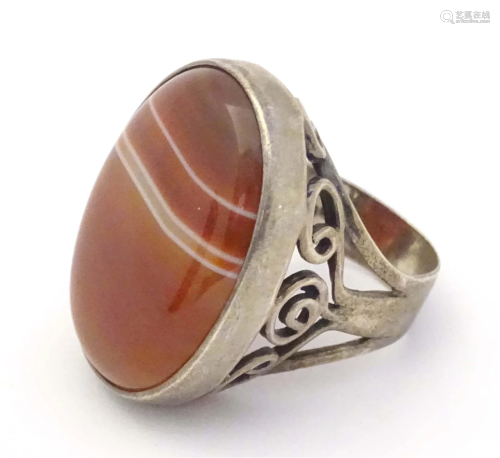 A silver dress ring set with agate cabochon. Hallmarked Lond...