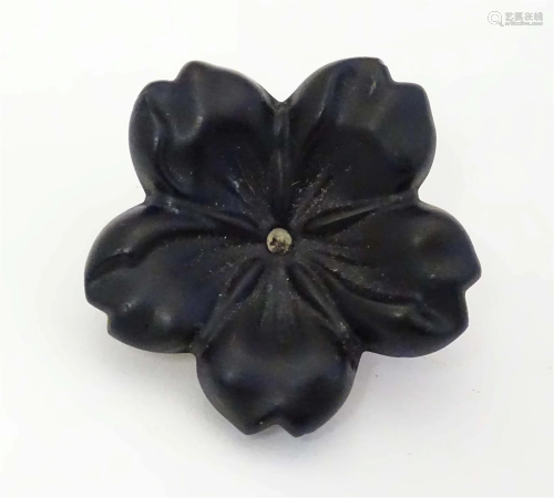A Victorian Whitby jet brooch of carved flower form with gil...
