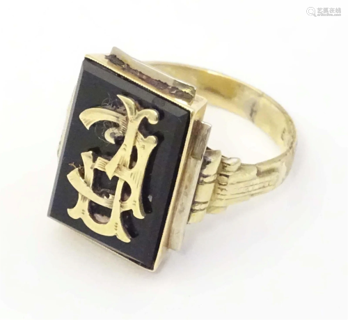 A 14ct gold signet ring with monogram detail. Ring size appr...