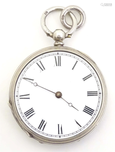 A white metal pocket watch. Approx. 1 1/2" diameter