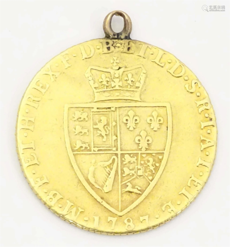 A George III 1787 gold coin with pendant loop to top. Approx...