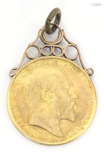 An Edward VII 1908 gold sovereign coin with pendant hanger t...