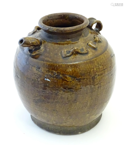 A Chinese salt glazed stoneware oil storage jar with applied...