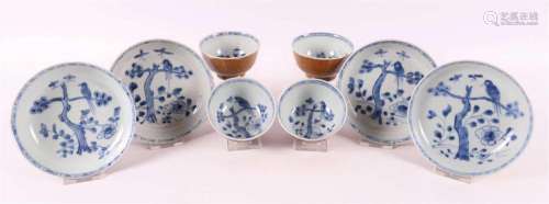 Four blue/white porcelain cups and saucers on capucine groun...