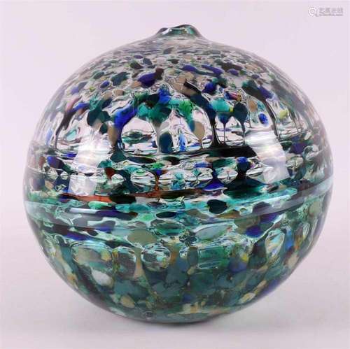 A thick-walled glass spherical vase with molten glass partic...