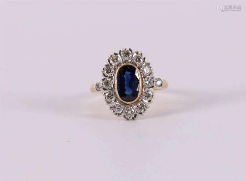 An 18 kt gold ring with an oval faceted blue sapphire and br...