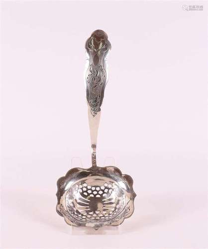 A 2nd grade silver sugar caster, hammered decor, year letter...