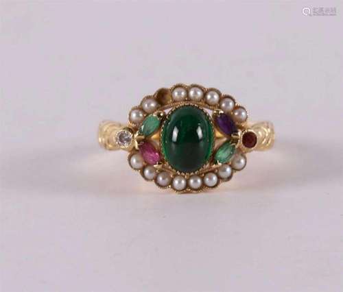 An 18 kt gold ring, set with colored stones and entourage of...