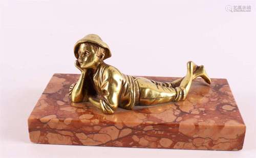 A bronze sculpture of a reclining boy on marble base, 20th c...