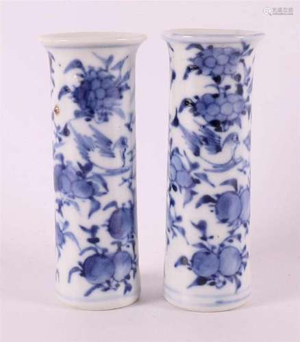 A pair of blue and white porcelain cylindrical miniature vas...