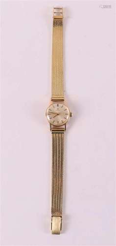 A round Omega women's wristwatch in a 14 kt case and gol...