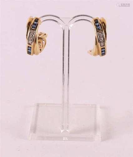 A pair of 14 kt gold earrings, set with three diamonds and b...